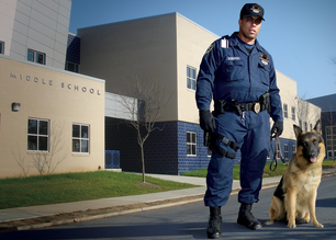 Security officer with canine guarding middle school